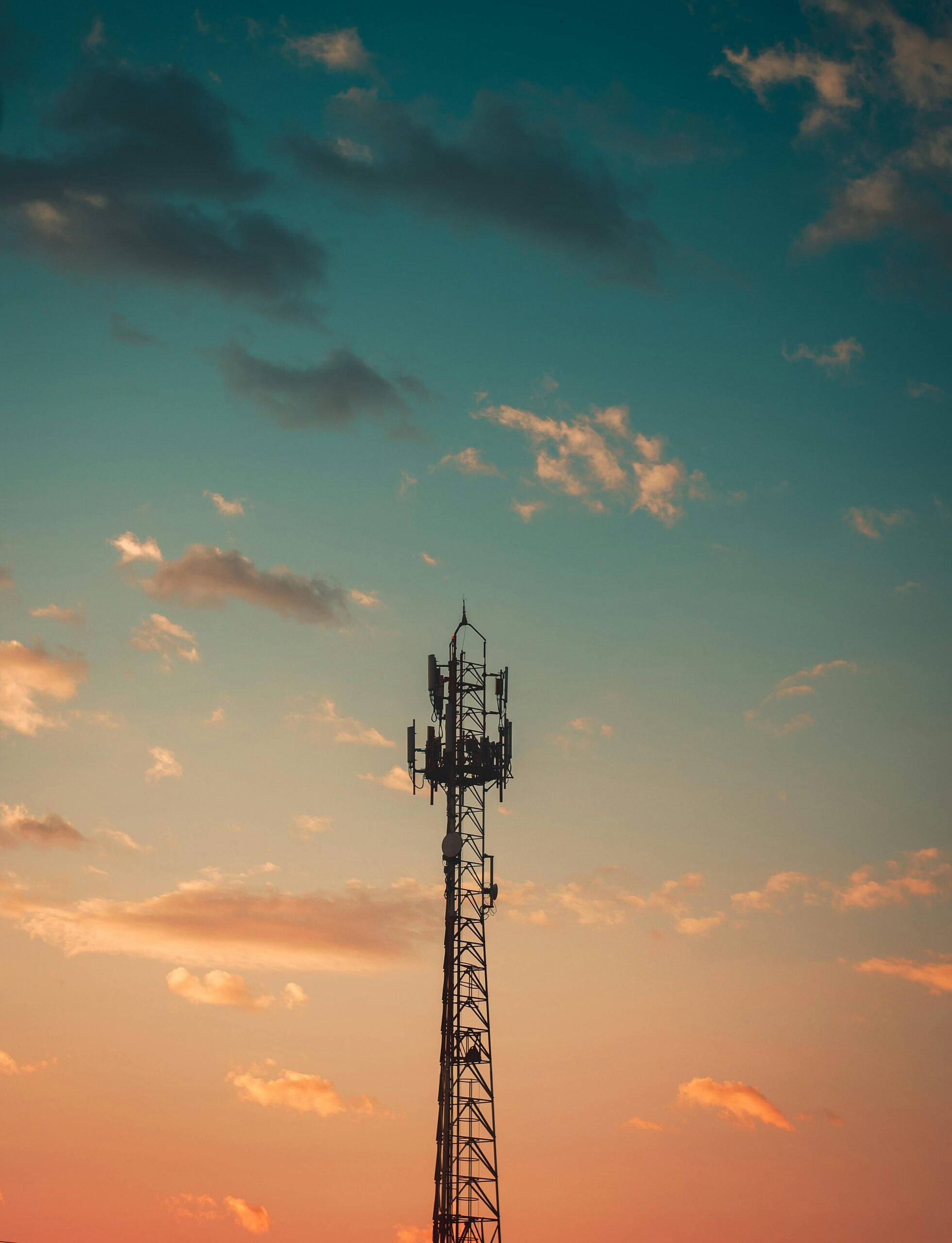 A mobile telecoms mast at sunset, representing advice before launching or changing a telecoms product