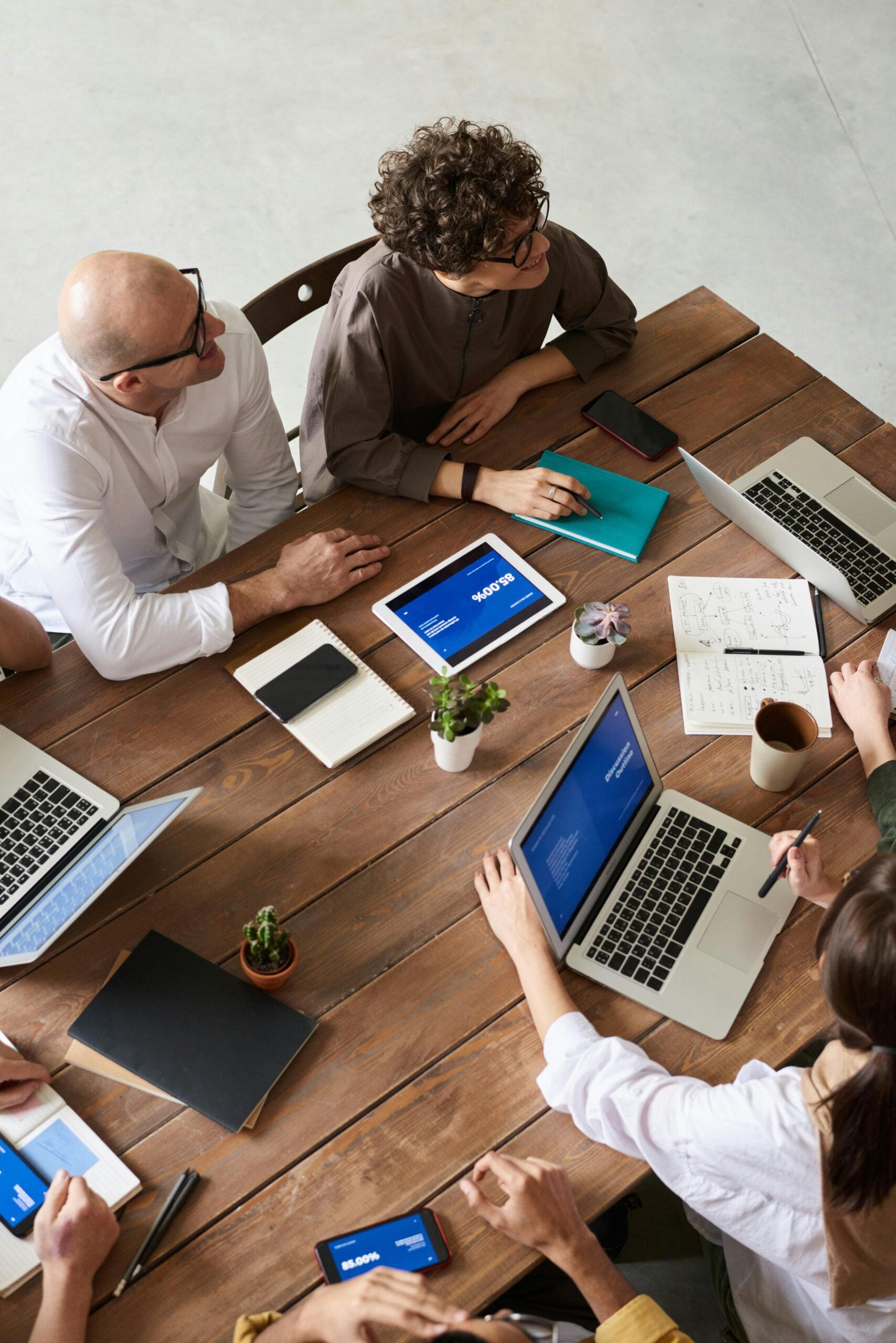 Advisers working through documents and laptops together at a table, representing disputes co-counsel support to other law firms